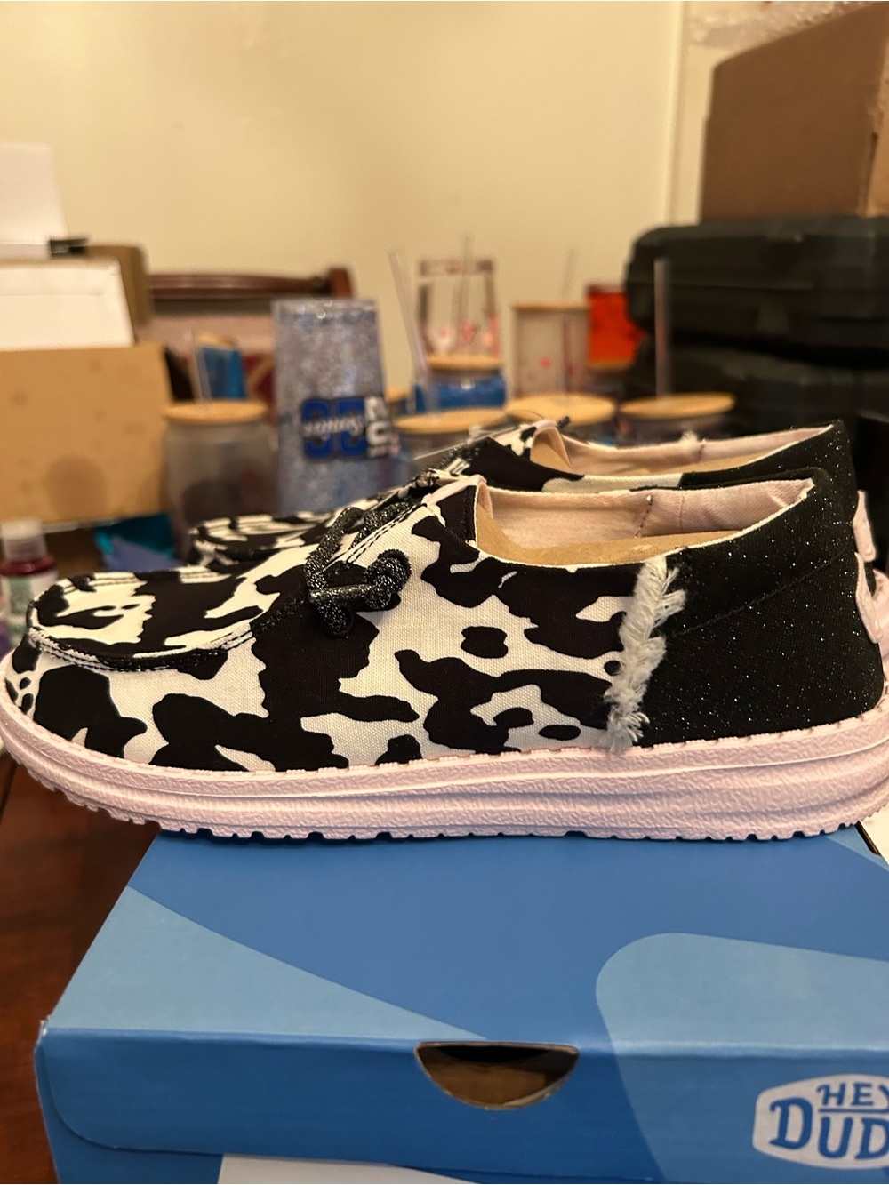 Hey Dude Women’s Black & White Cowprint Slip-On Sneakers with Pink Sole